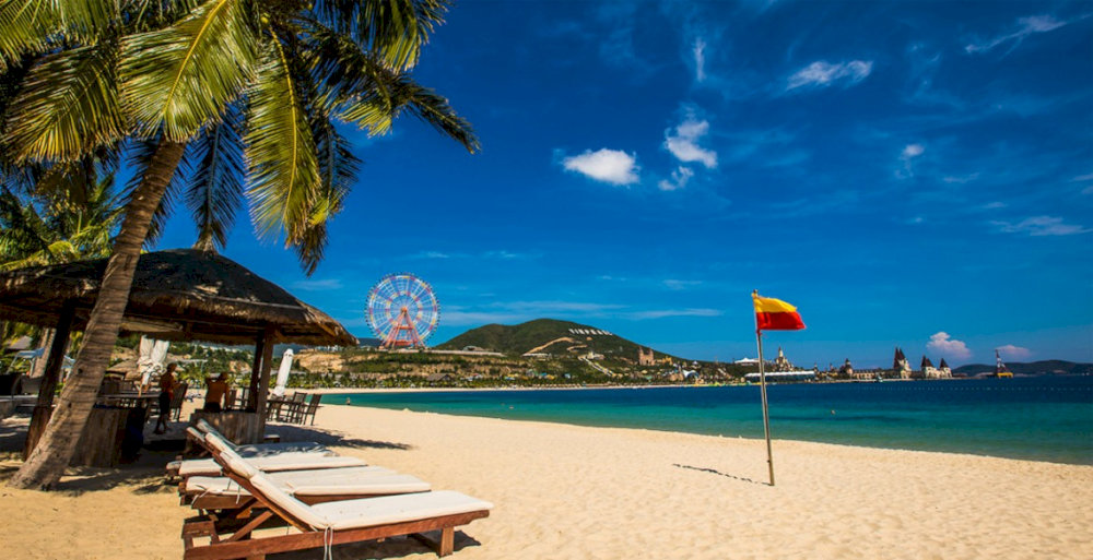 This beach offers white sand, turquoise water, and peaceful coconut trees
